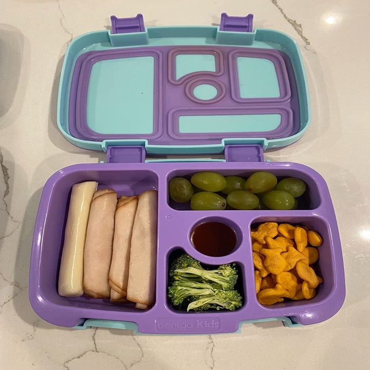 a reviewer photo of the lunchbox with a variety of foods inside