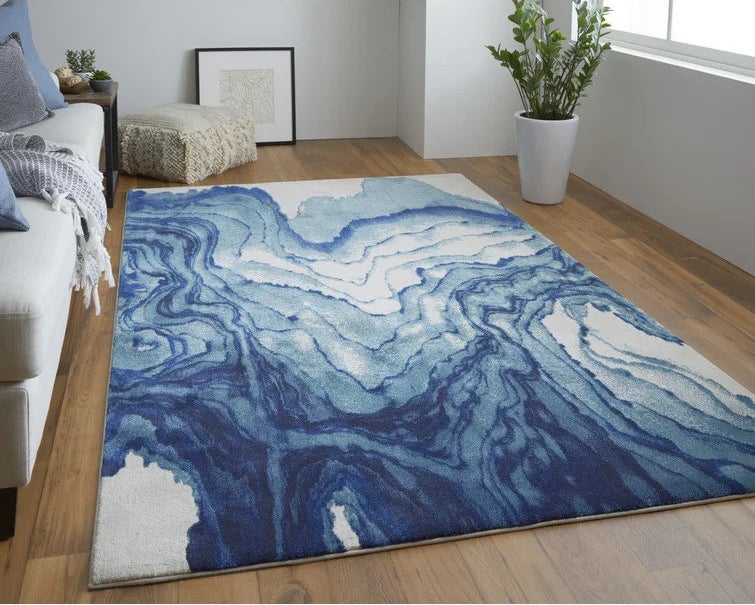 Blue rectangular rug on hardwood floor in living room