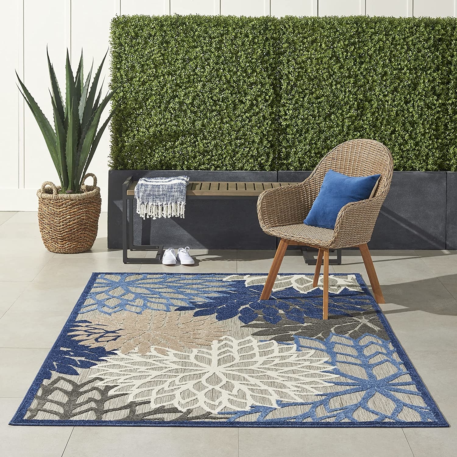 floral rug in shades of blue and gray outside on a patio with furniture
