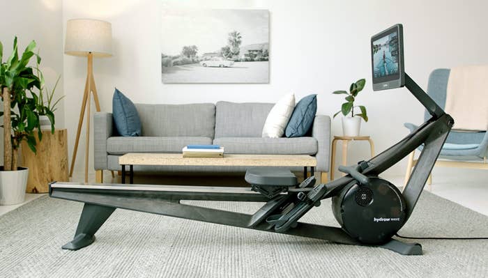 A Hydrow Wave rowing machine, all set up and ready to go in a small living room.