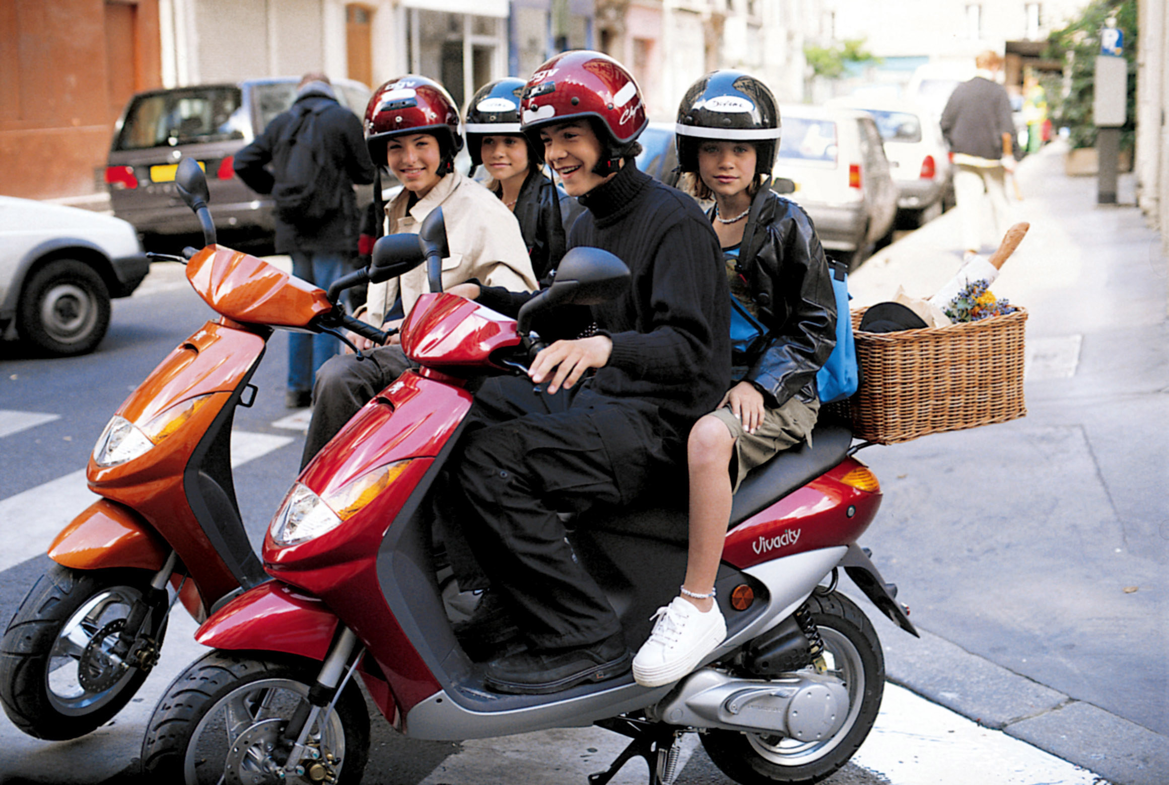 Ethan Peck, Brocker Way, Mary Kate Olsen, and Ashley Olsen riding on mopeds.