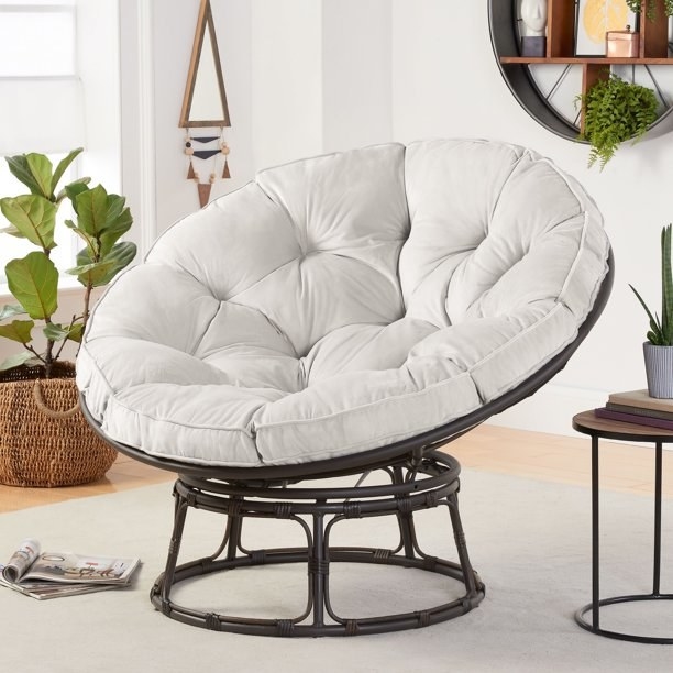 Round chair with large round gray cushion and black base