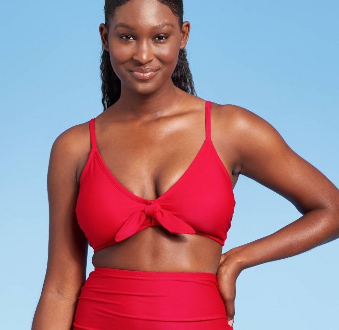 model wearing red tie-front bikini