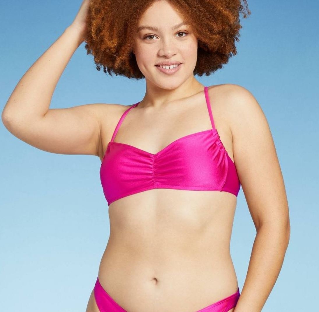 model wearing shiny pink bralette bikini