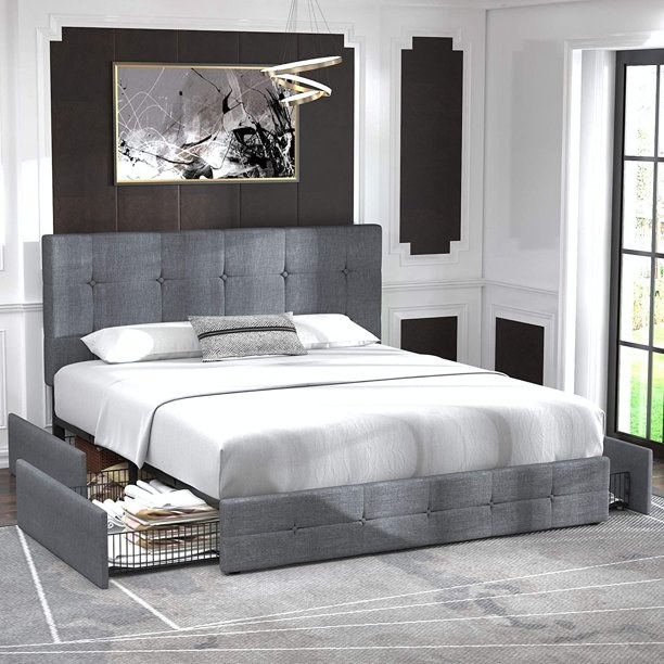 Gray tufted bedframe with two side drawers slid out on the bottom