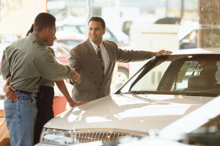 car dealer selling a car to a couple