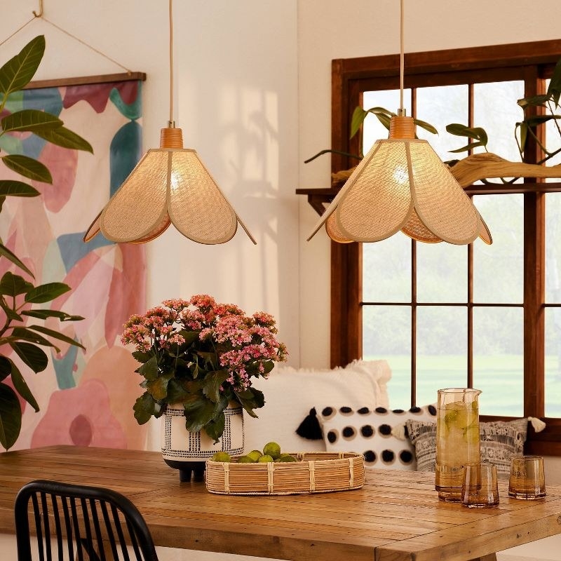 the pendant lamps hanging over a dining table