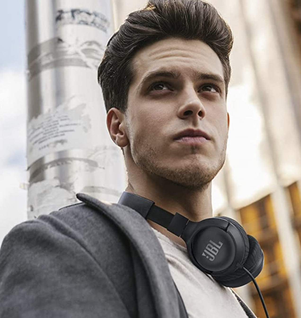 a person with the headphones around their neck