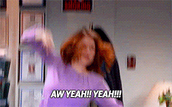 a gif of ellie kemper from the office pumping her fist and yelling aw yeah!