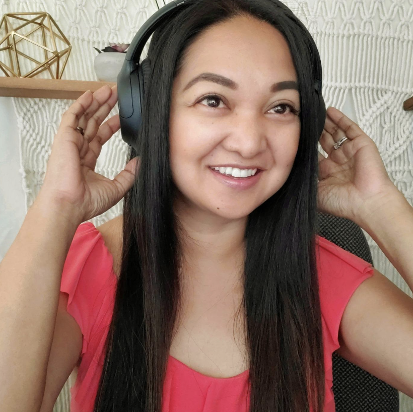 reviewer wearing headphones and smiling