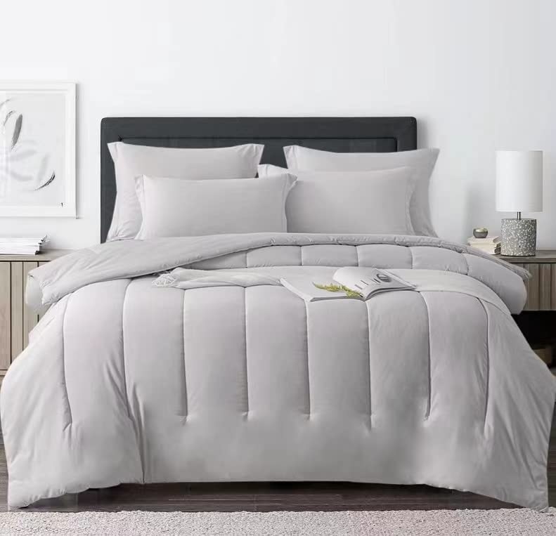 The grey comforter set on a bed