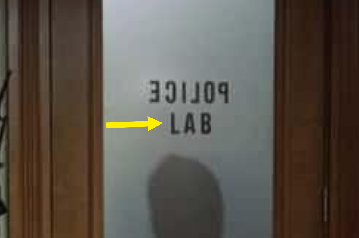 Close up of a door with police backwards and lab written forwards