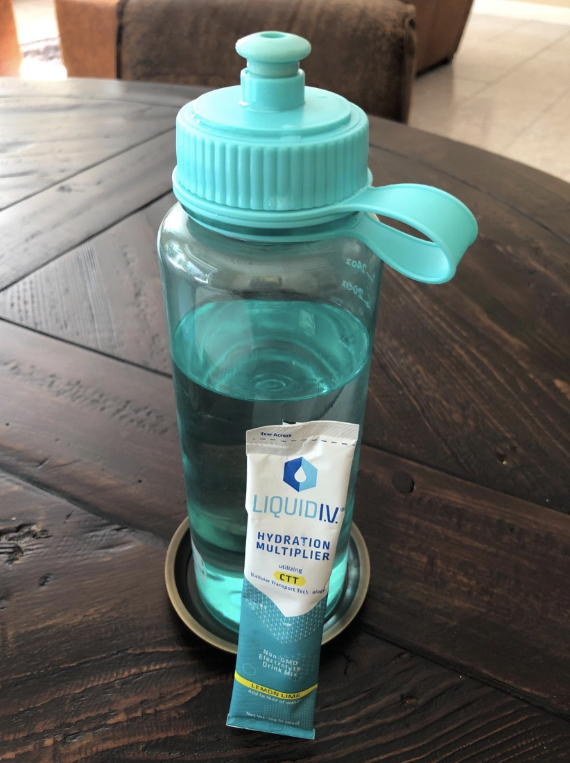 Reviewer image of a water bottle next to a hydration packet