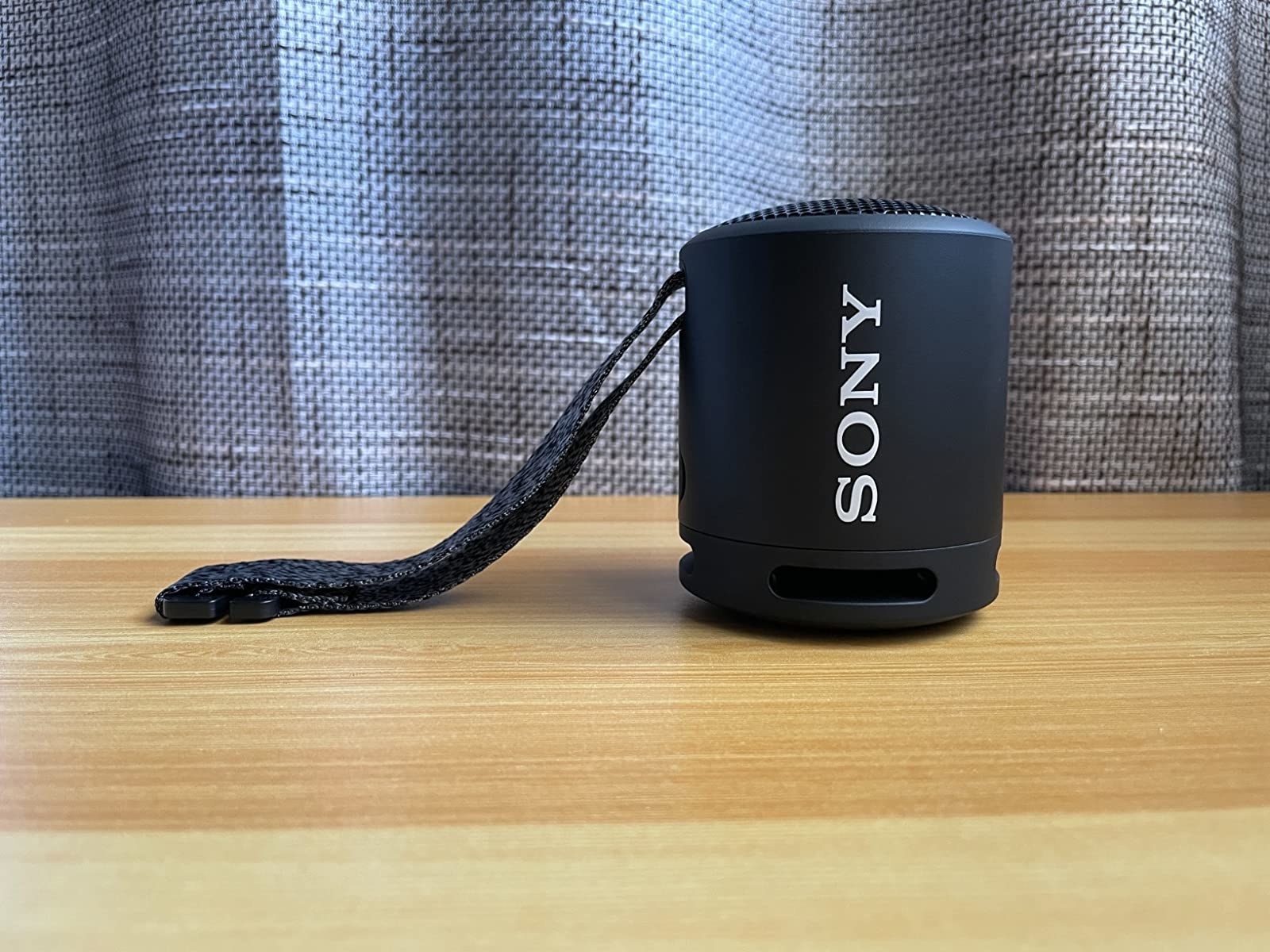 reviewer photo of the black sony speaker with a strap