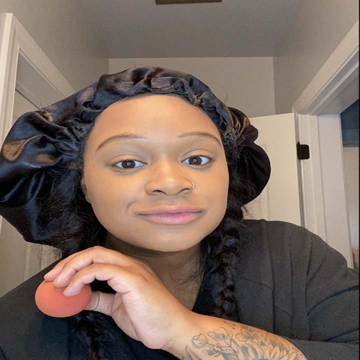 Reviewer with foundation blended on their face from the sponge