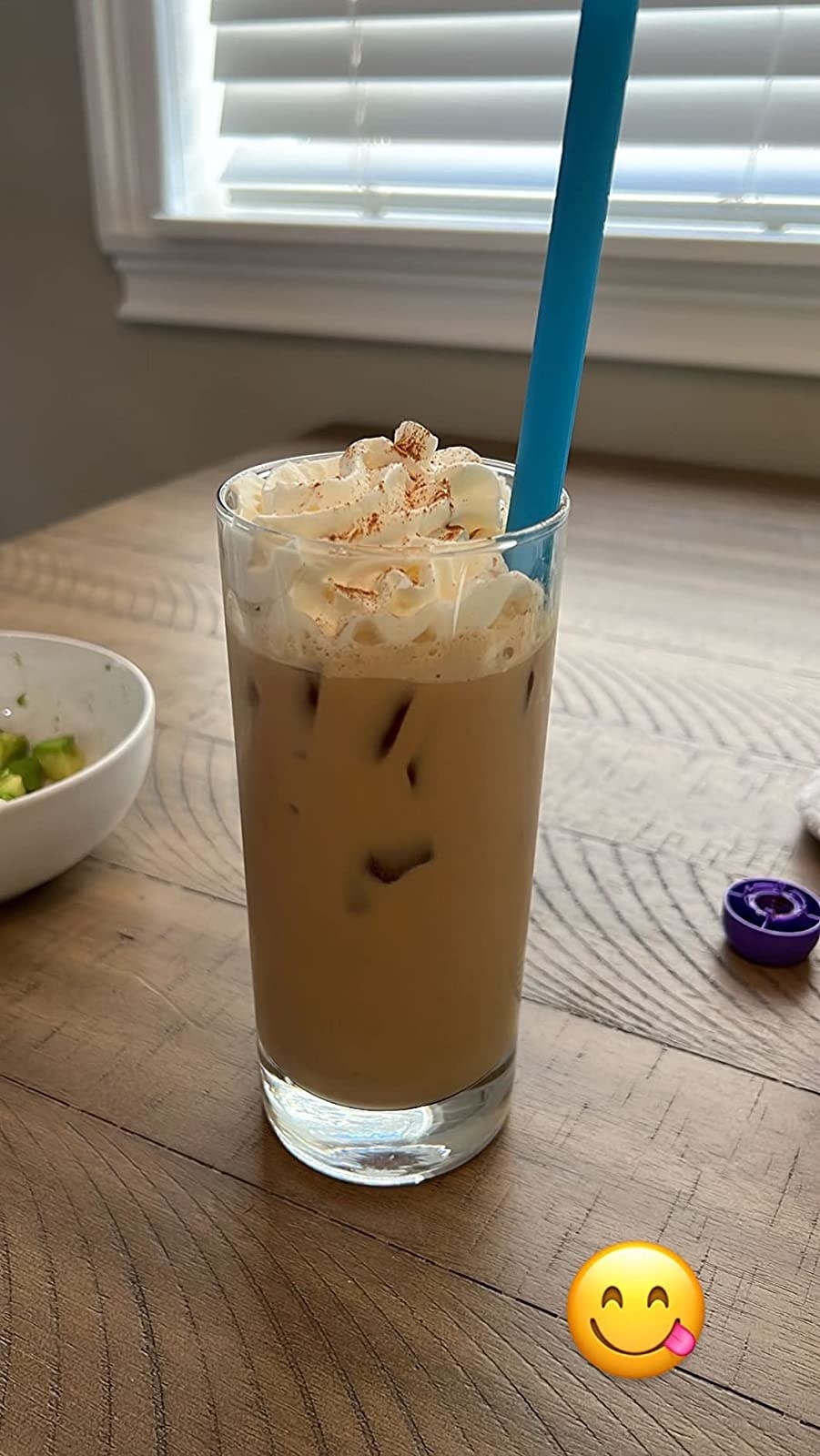 An iced coffee with whipped cream