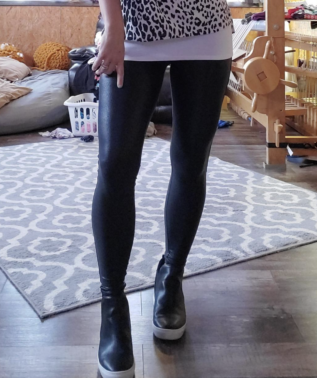 Reviewer in black faux leather leggings