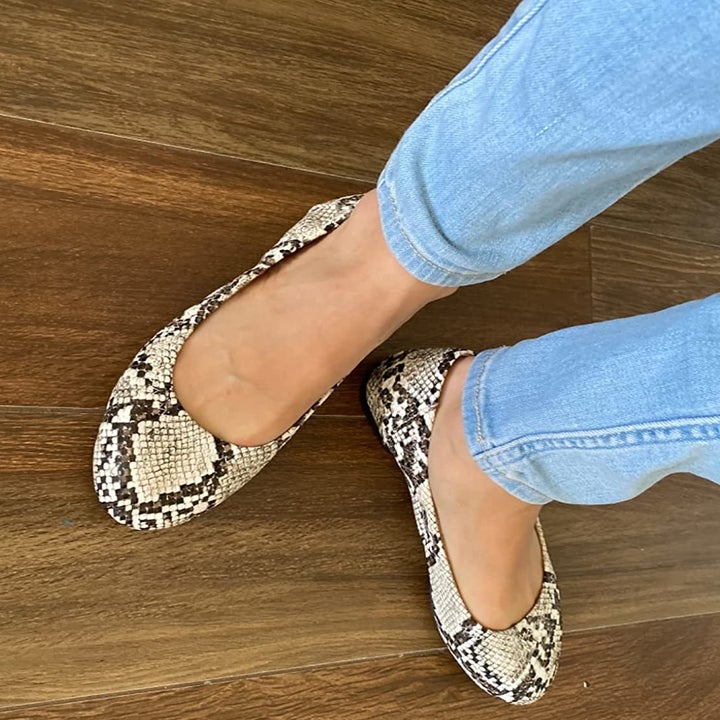 reviewer wearing the snakeskin flats