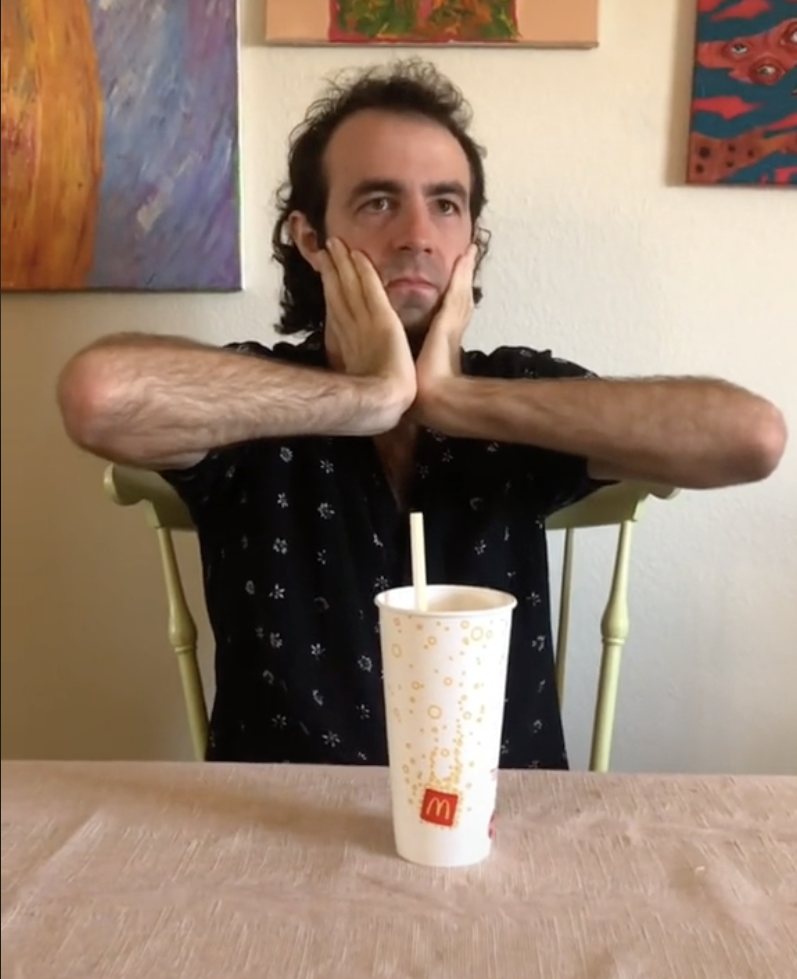Davey sits in front of a single McDonald&#x27;s cup, with his hands on his face, looking very concerned