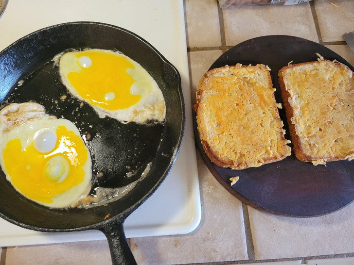 Two eggs frying in a pan