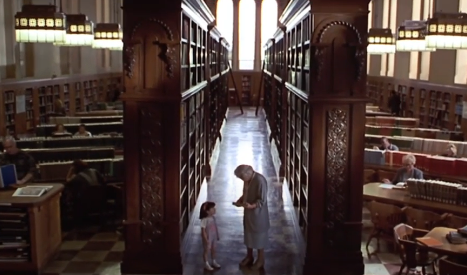 A little girl and an older woman in a library