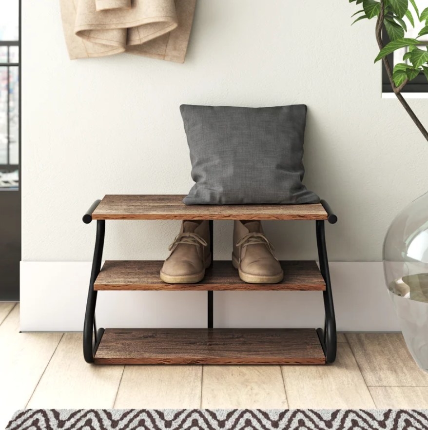 Shoe rack with boots and cushion on shelves