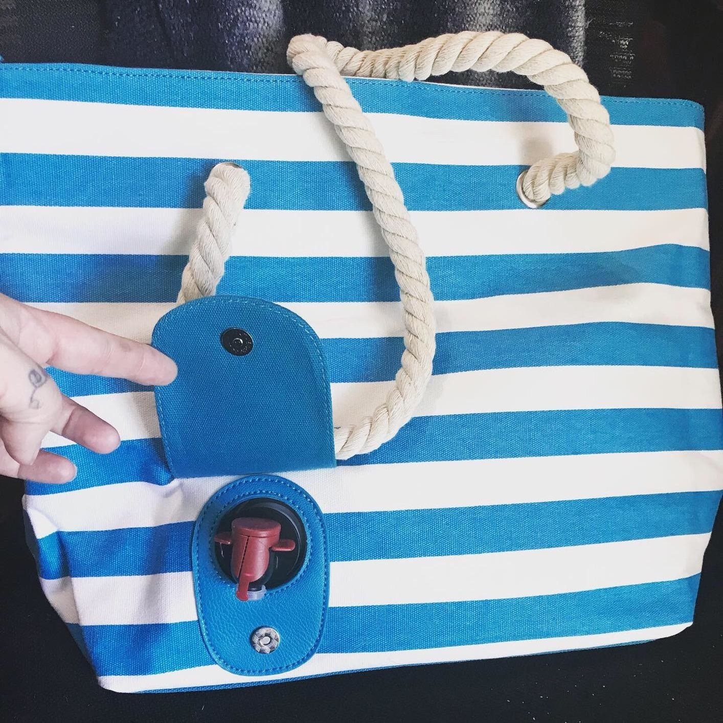 blue and white striped beach bag with a spout for wine