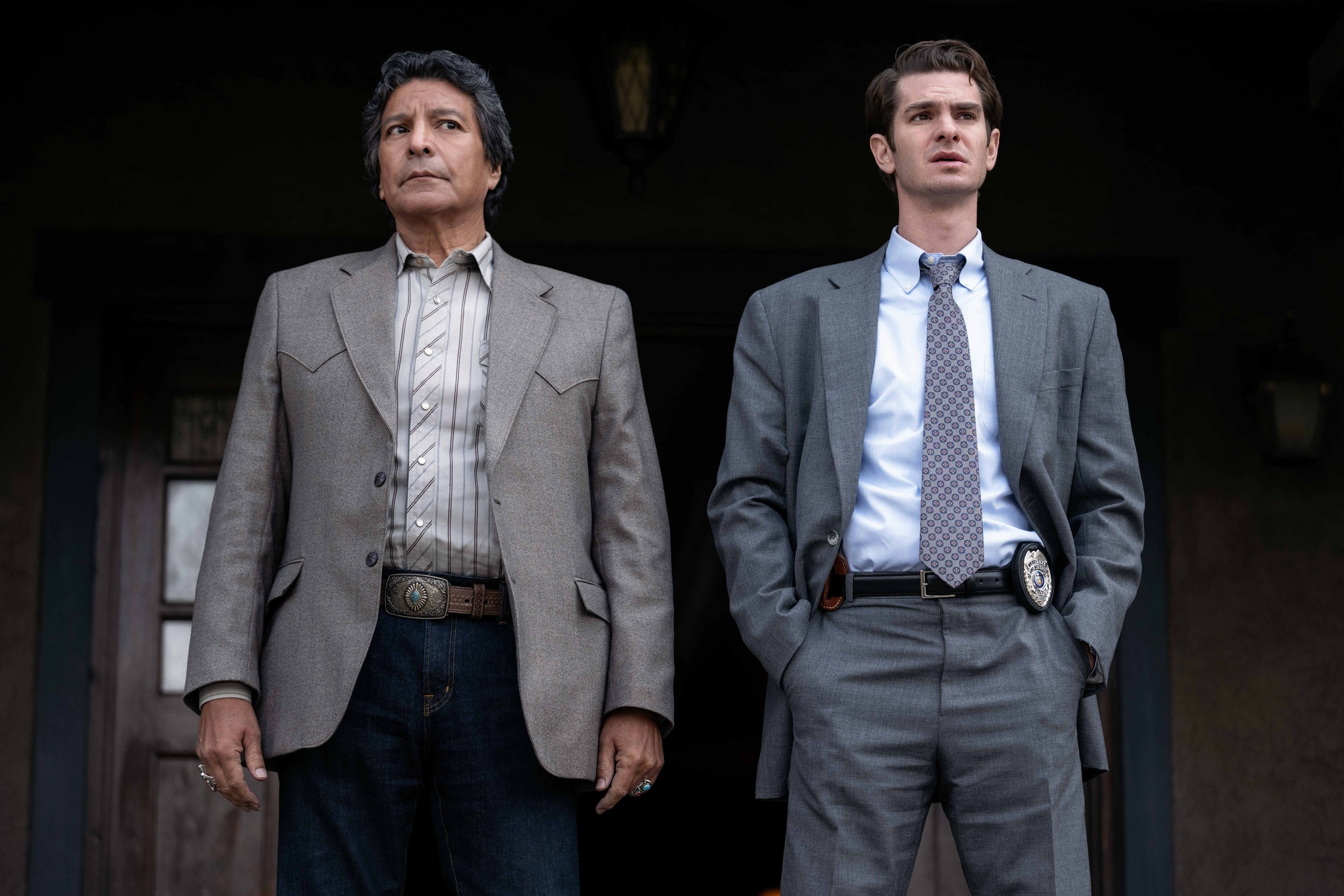 Gil Birmingham and Andrew Garfield look off a porch