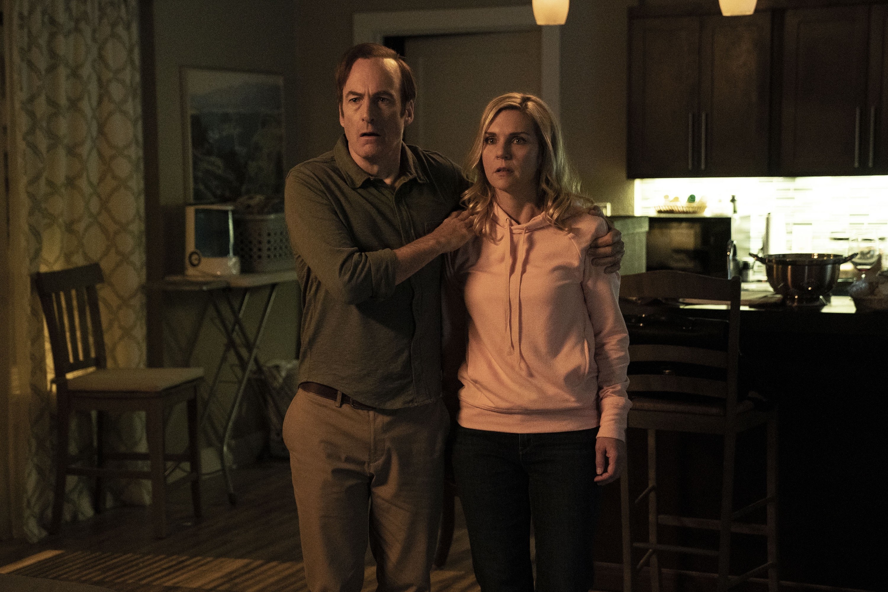 Bob Odenkirk and Rhea Seehorn stand in a living room
