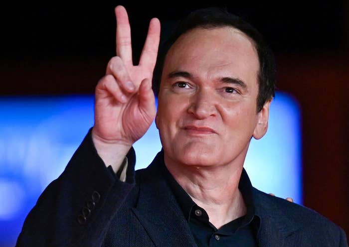 Quentin Tarantino showing the peace sign at the 16th Rome film festival in 2021