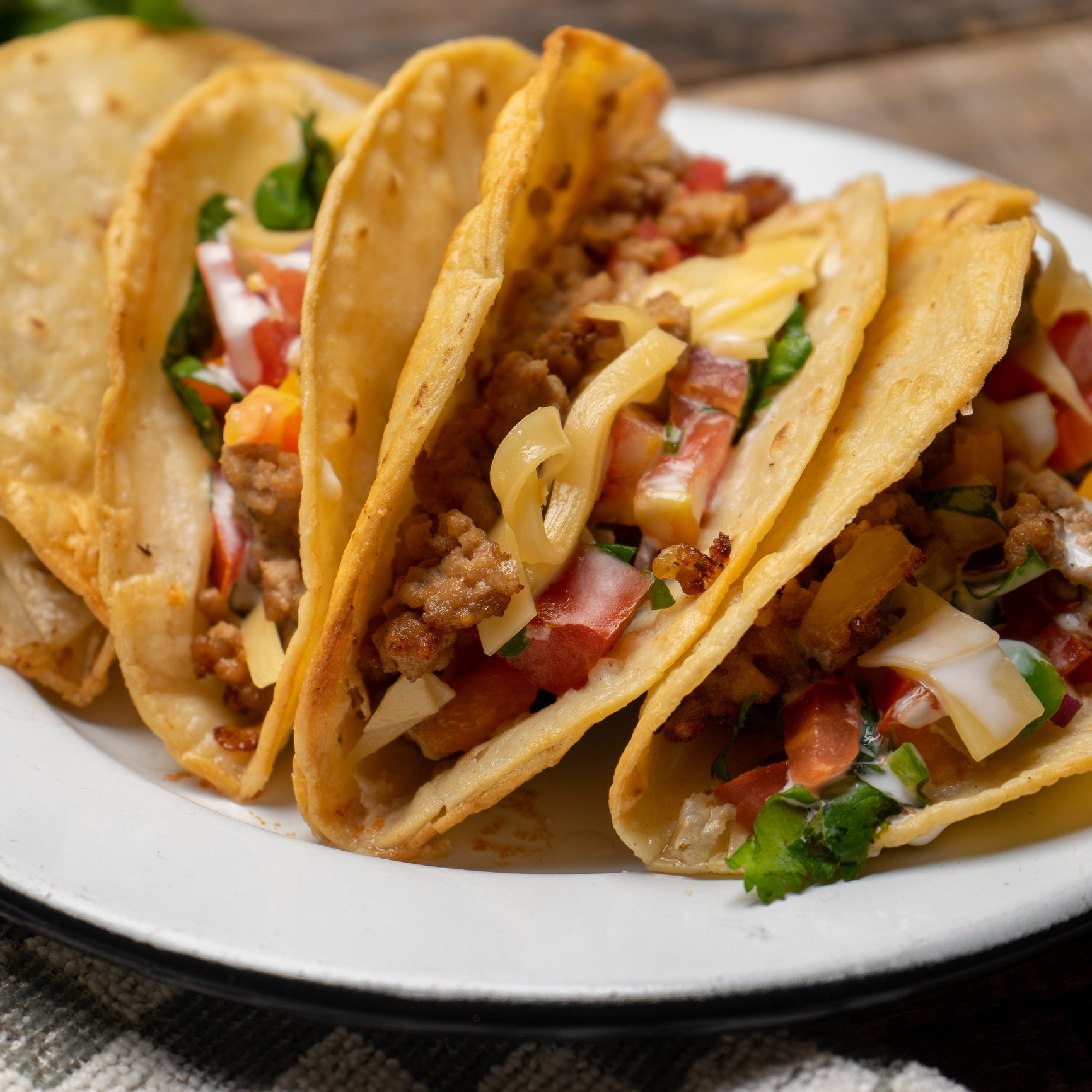 Mexican hard-shell tacos filled with meat and vegetables.