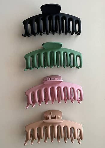 reviewer photo of four hair claws in different colors