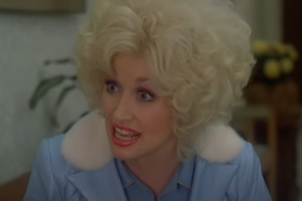 Dolly Parton as Doralee looking excited