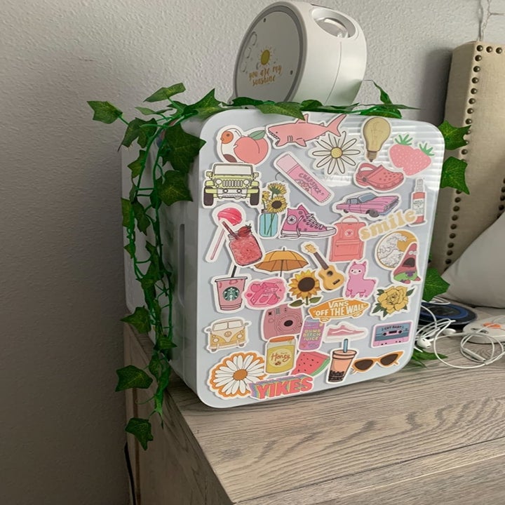 a reviewer photo of the front of the fridge that someone decorated with stickers