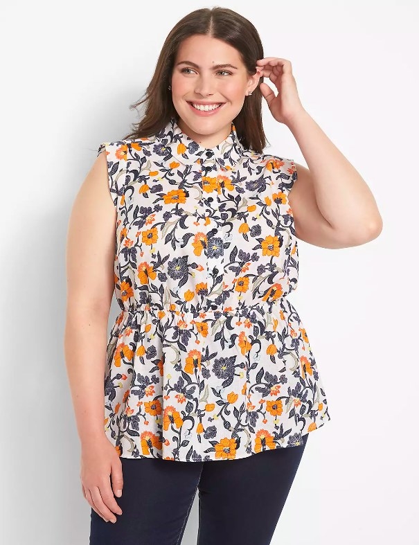 Model wearing floral print top and dark wash jeans