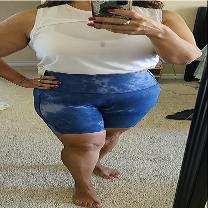 reviewer wearing the blue and white shorts with a white tank
