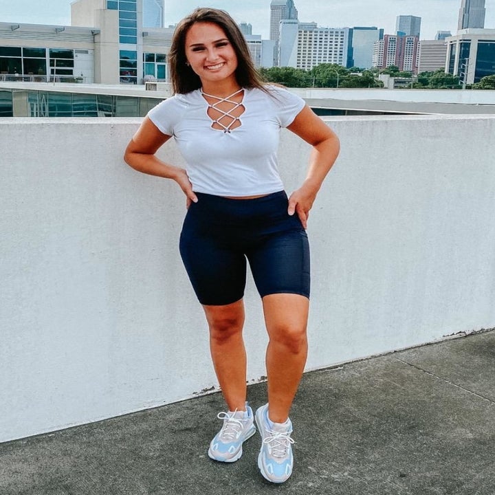 reviewer wearing the black shorts with a white top and sneakers