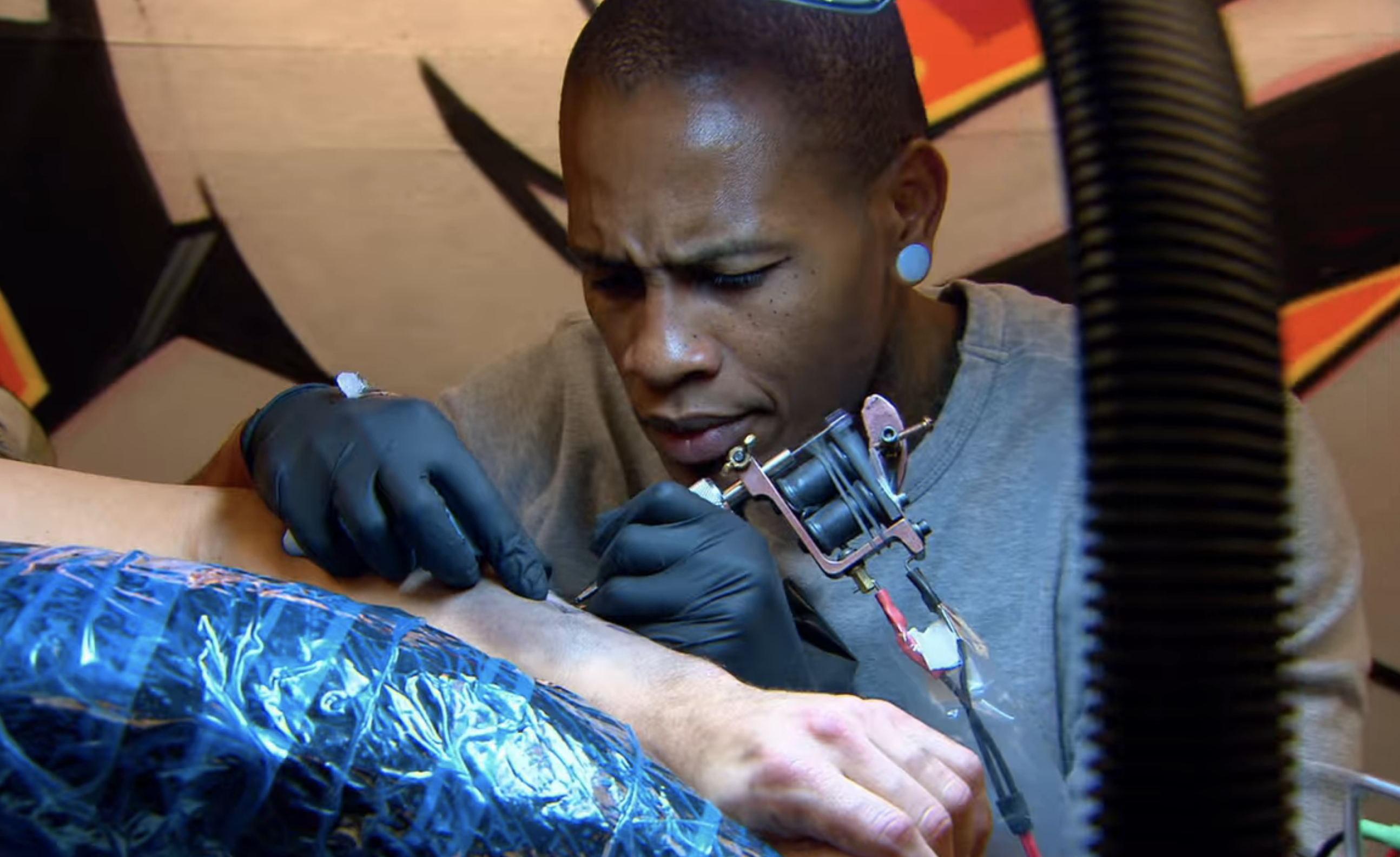 A tattoo artist working