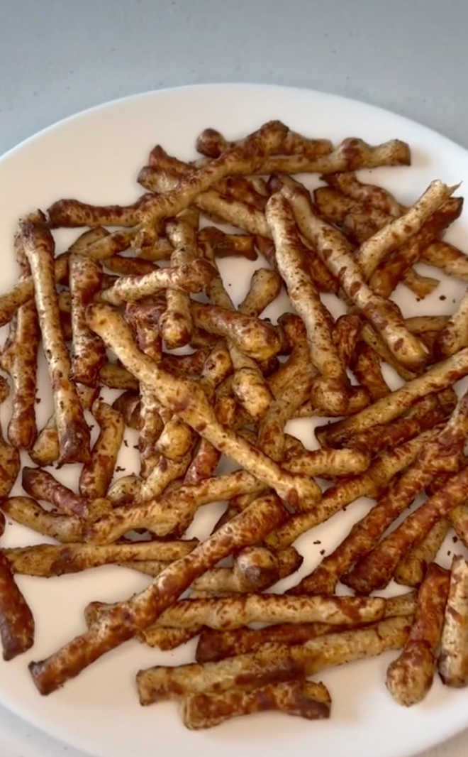 A plate full of Twiglets, which look similar to pretzel sticks coating with seasoning