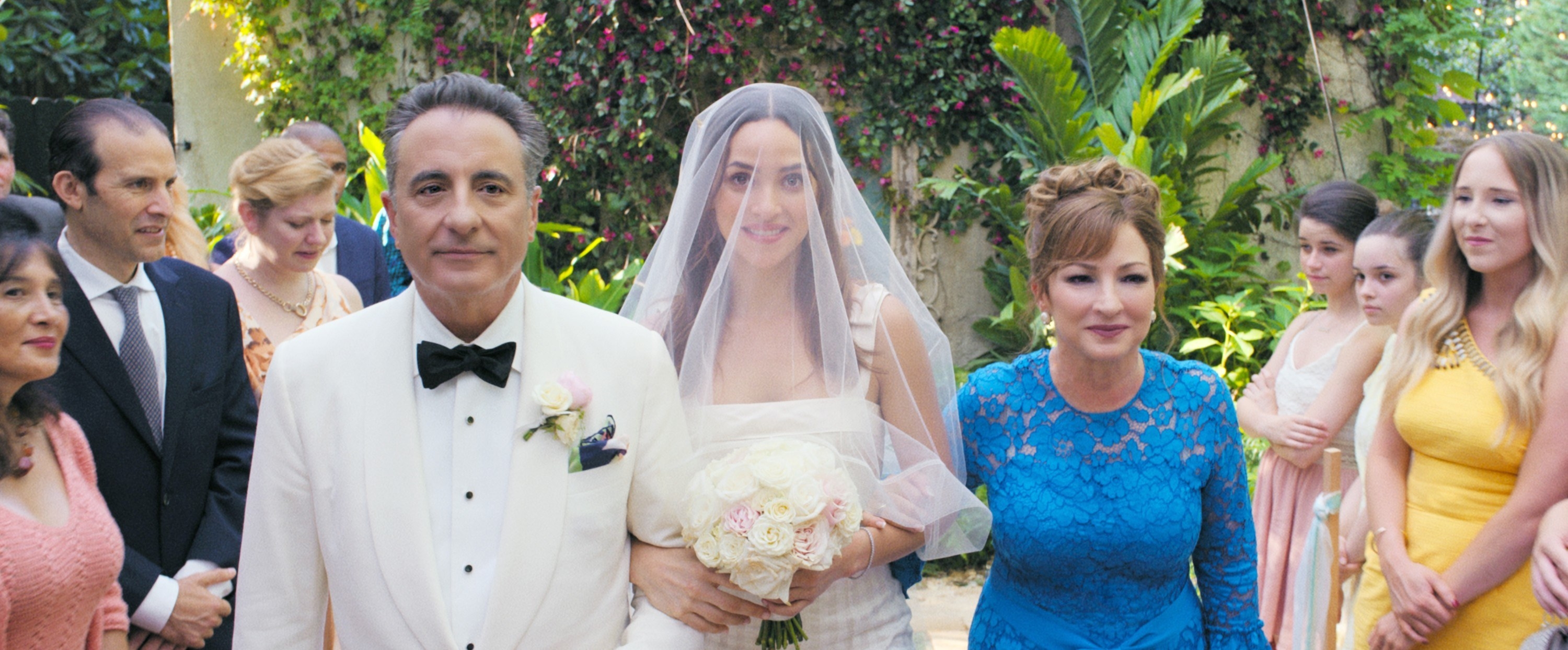 Andy Garcia, Adria Arjona, Gloria Estefan walking down the aisle at a wedding