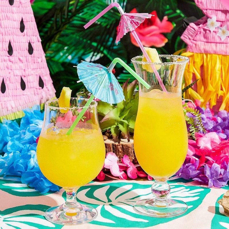two fruity drinks with the umbrellas in them