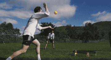 a gif of four people playing spikeball