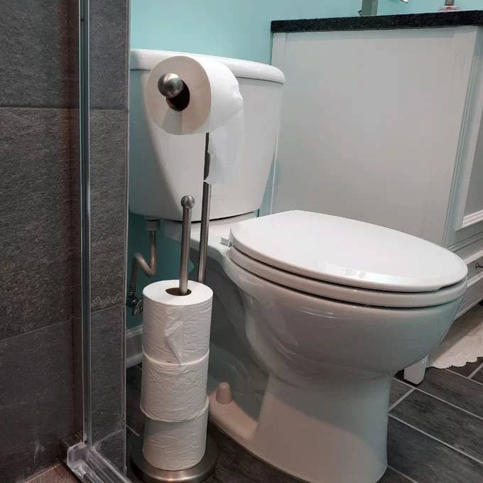 A toilet paper holder with extra rolls