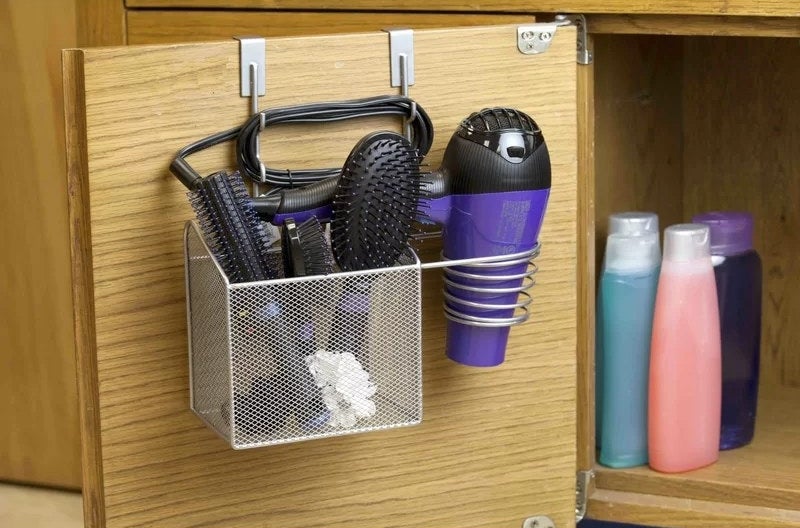 Over-the-door hair tool organizer made from a metal wire mesh basket and blowdryer caddy