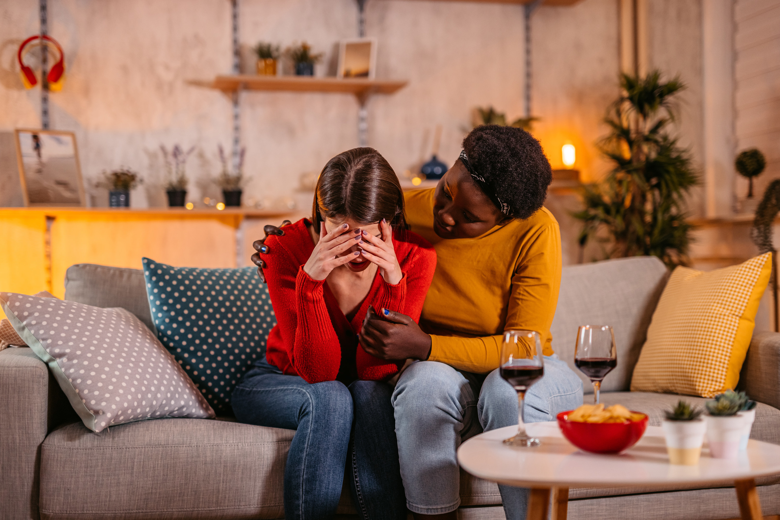 a woman consoling another woman