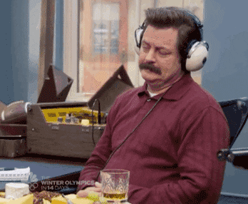 A man with a marvelous mustache bopping his head to music