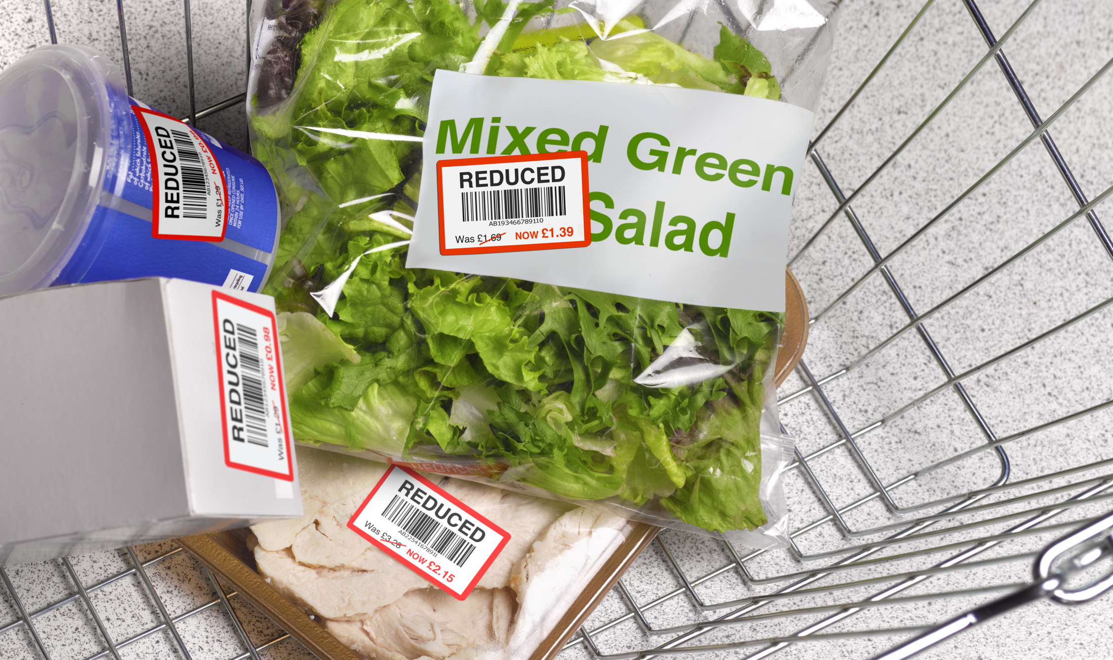 A cart full of groceries marked as &quot;reduced&quot; price