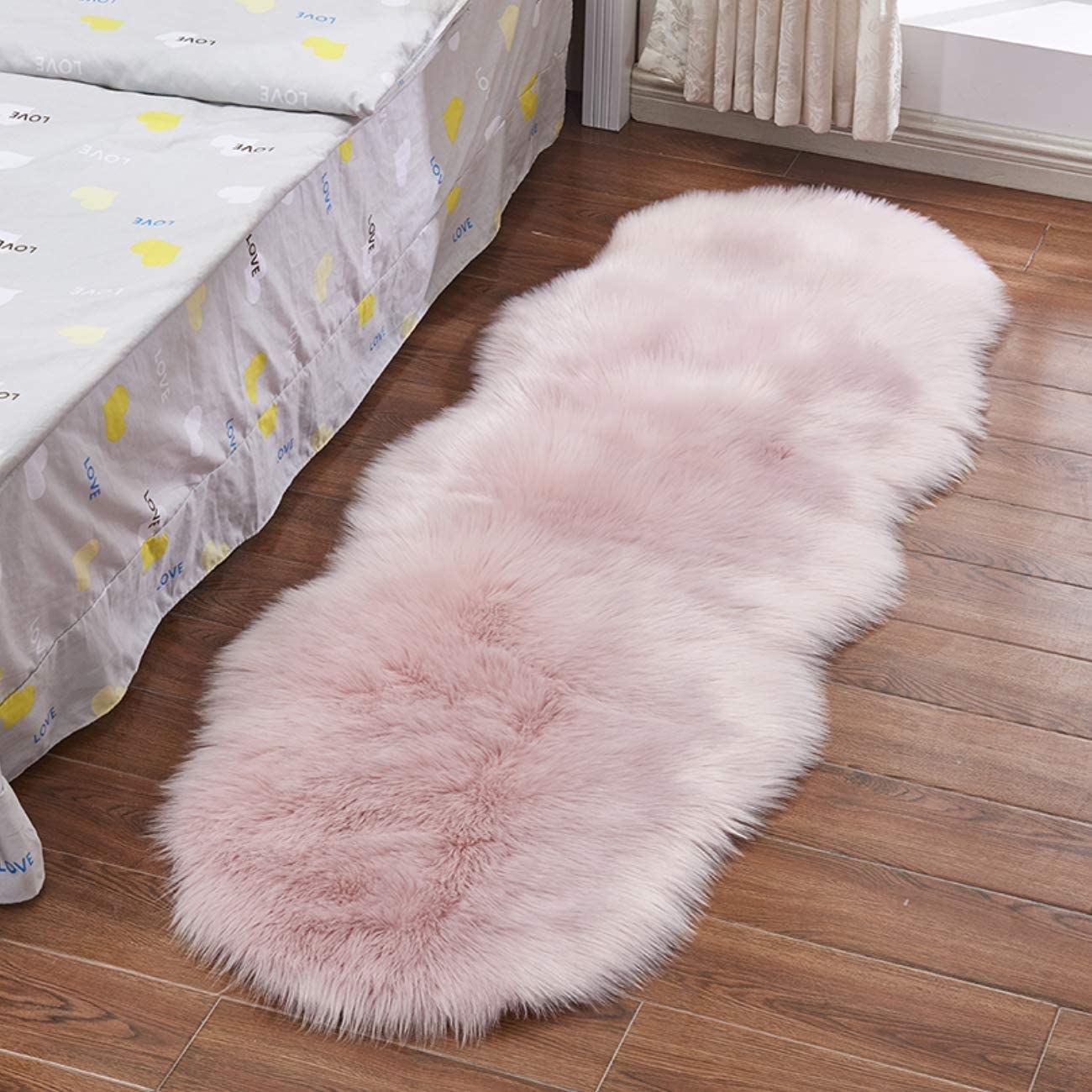 a shaggy faux fur rug next to a bed