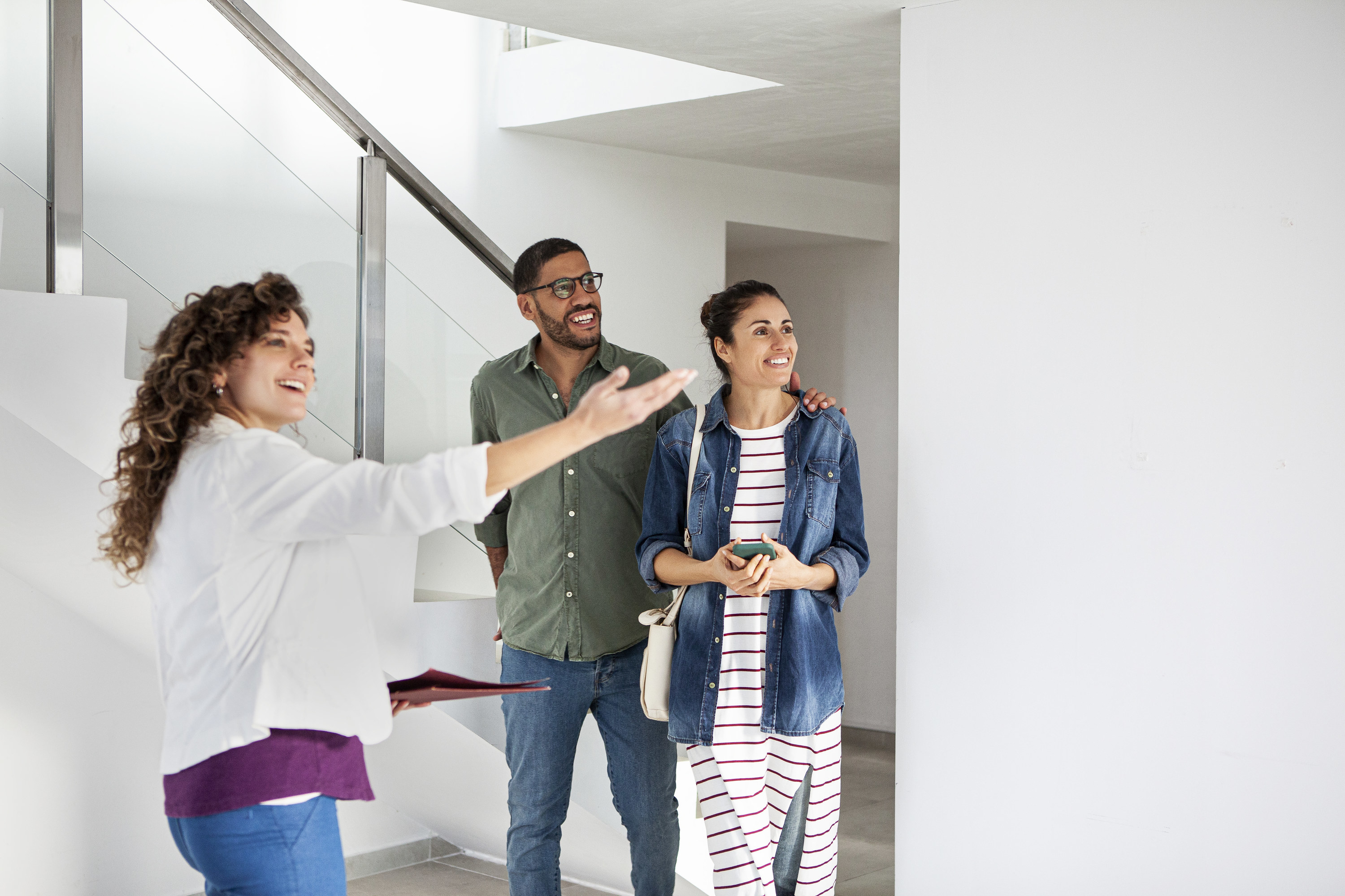 a realtor showing a couple a home