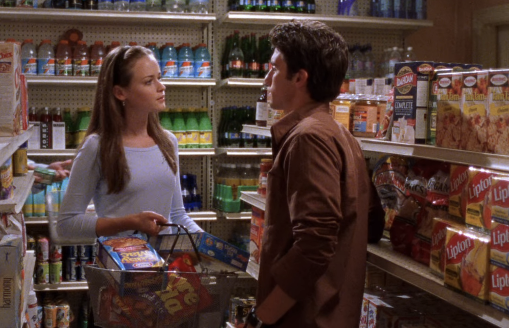Two people talking while grocery shopping
